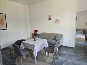 a living room with a table and a couch at Apartmani Korana in Karlovac