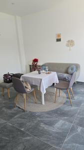 a dining room with a white table and chairs at Apartmani Korana in Karlovac