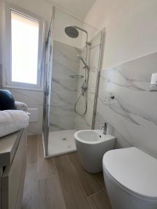 a bathroom with a shower and a toilet and a sink at Trinacria Bedda Spinazza con Piscina in Marzamemi +4 photos