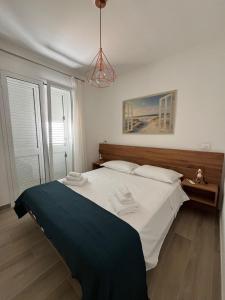 a bedroom with a large bed with white sheets at Trinacria Bedda Spinazza con Piscina in Marzamemi +4 photos