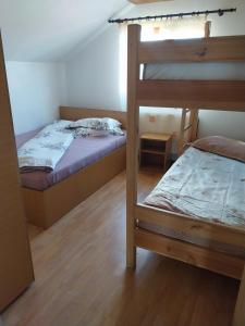 a bedroom with two bunk beds and a bed at Cabana Ioana Balas in Beliş
