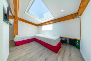 a bedroom with a bed and a skylight at Elegant duplex, very well equipped, close to shops in Cannes