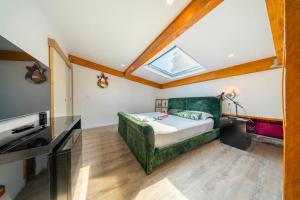 a bedroom with a bed and a skylight at Elegant duplex, very well equipped, close to shops in Cannes