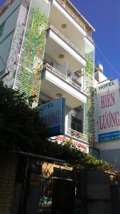 a tall white building with signs in front of it at Hien Luong Hotel in Nha Trang