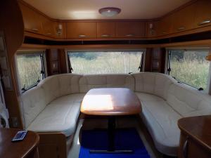 a living room with a couch and a table at Caravan du Loch in Gaël