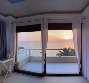 a room with a window with a view of the ocean at Villa Sunset Siviri in Siviri +21 photos