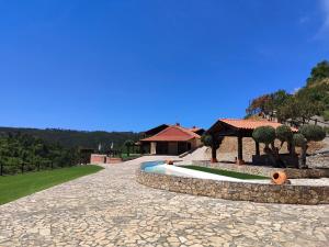 a resort with a swimming pool and a house at Lake Prestige Villa Castelo de Bode, Tomar in Tomar