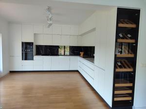 a kitchen with white walls and wooden floors at Lake Prestige Villa Castelo de Bode, Tomar in Tomar