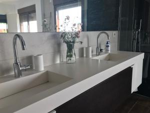 a kitchen with two sinks and two faucets at Villa Xauxa - Vida mediterránea in Gandía +39 photos