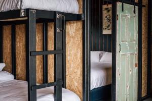a couple of bunk beds in a room with a door at Humbug Views - Bunk House & Hot Tub! in St Helens
