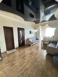 a large living room with a couch and a table at Apartment for rent daily ქირავდება ბინა დღიურად in Mejinistsqali