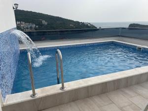 a swimming pool with a water fountain at Morski plamen in Kruče