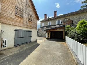 a garage entrance to a building with a barn at Appartement Cocoon avec jardin et vue montagne in Laruns