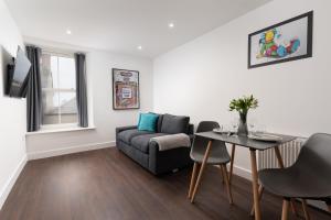 a living room with a couch and a table at Room 2 Hotel style Double bedroom in Marazion in Marazion