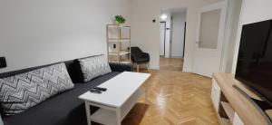 a living room with a couch and a table at Scandi on Flowers street in Chişinău