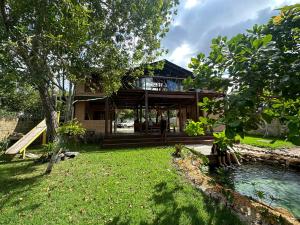 a house with a pond in front of it at Casa do Lago em Alter do Chão in Alter do Chao