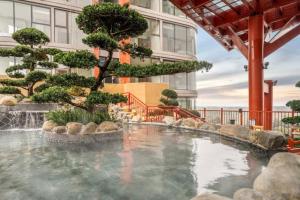 a large pool of water in front of a building at Onsen Landmark Ecopark in Cong Luận