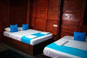 Postel nebo postele na pokoji v ubytování Ceylon Amigos Eco Resort