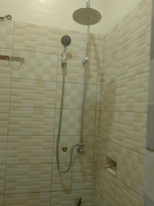 a shower with a glass door in a bathroom at Wana Guest House in Rubirizi