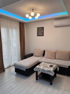 a living room with two beds and a table at ID apartments in Tivat