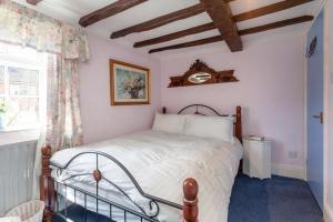 a bedroom with a bed and a window at Rosehip Cottage Period home, Bingham, Nottingham in Bingham +13 photos