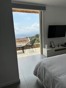 a bedroom with a bed and a large sliding glass door at Casa La Vista in Bastia