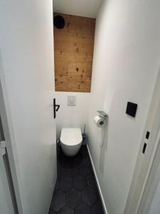 ein Badezimmer mit einem WC und einer Holzdecke in der Unterkunft LOUBATIERE, Superbe Appartement rénové au Coeur de la Station in Montgenèvre + 3 Fotos