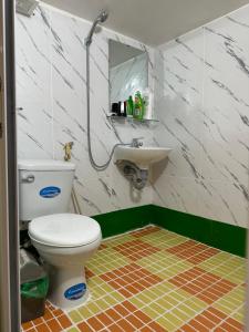 a bathroom with a toilet and a sink at Kolor Red Home,Bungalow Old Quarter,4 paxs,3 mins to Hoan Kiem Lake in Hanoi