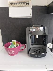 a coffee maker and a bowl on a counter at La famille in Angoulême