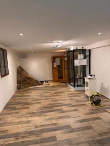 an empty room with a hardwood floor and a glass door at Chalet d’Ax Pyrénées in Ax-les-Thermes