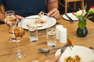 a person sitting at a table with a plate of food at Stoke Lodge Hotel in Stoke Fleming