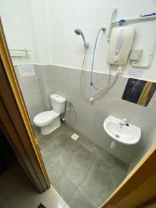 un baño con inodoro y lavabo en Sungai Udang Homestay 4 bilik dengan 2 loteng atas, en Melaka 26 fotos más