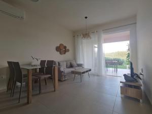 una sala de estar con una mesa y un sofá en 两卧室公寓-带露台花园, en La Canea