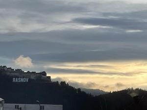 a building on top of a hill with the sky at NowHere Rasnov in Râşnov