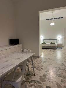 a living room with a table and chairs and a couch at VENTINOVE Apartments in Otranto