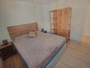 a bedroom with a large bed with a wooden headboard at Apartment near sea Nortico 5 Torrevieja Spain in Torrevieja