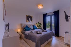 a bedroom with a large bed with blue pillows at Apartment Villa Dolce Vita Korcula in Lumbarda +58 photos