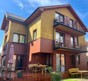 a colorful house with a table and a patio at Pas Bani in Palanga