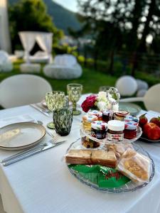 a white table with a plate of food on it at Boutique Hotel Municipio 1815 in Valdobbiadene