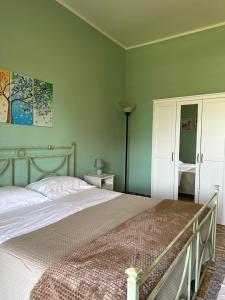 a bedroom with a bed and a painting on the wall at Garden House B&B in Striano