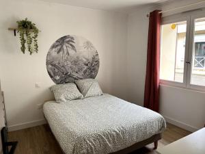 a bedroom with a bed with a round head board at Appartement in Tombeboeuf