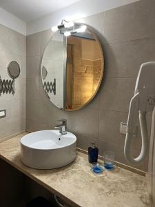 a bathroom with a sink and a mirror at VENTINOVE Apartments in Otranto +52 photos