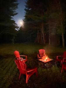 a group of chairs around a fire pit at night at Bancroft VIBES l Sleep 7 l BBQ I FIRE PIT in Bancroft
