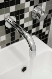 a white bathroom sink with a chrome faucet at Majestic Minima Hotel in Adelaide +17 photos