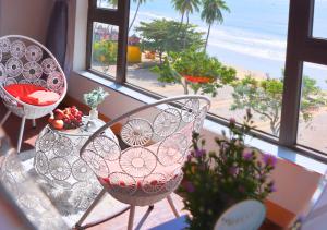 a balcony with two chairs and a table with a view of the beach at Sontra Sea Hotel in Danang