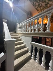 a staircase with white railings in a building at Lidas Golden View-All around veranda apartment in Nafplio +29 photos