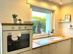 a kitchen with a stove and a sink and a window at Ca del Gno in Luni +77 photos