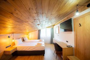 a bedroom with a bed and a wooden ceiling at Casa Hirsch in Avrig +18 photos