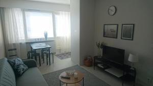 a living room with a couch and a table at Apartment Rauha in Rovaniemi