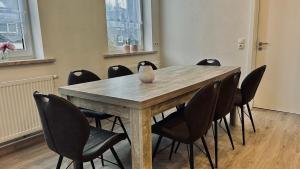 a conference room with a wooden table and chairs at Ingrid in Schwarzatal